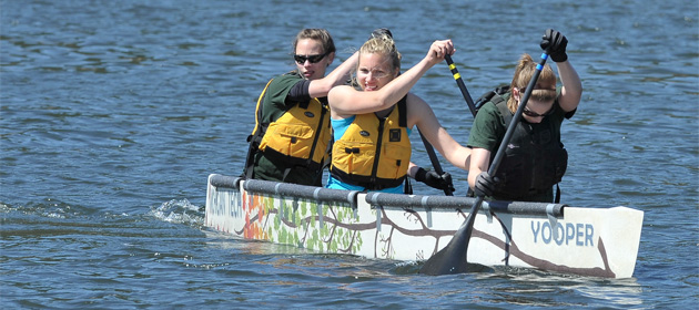 Michigan Tech's Concrete Canoe team aboard their canoe, the Yooper.