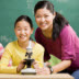 photo of a teacher and student with a microscope.