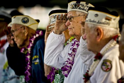 Edgar Harrison, center, a Pearl Harbor survivor and World War II veteran, salutes as the national anthem is played during a remembrance ceremony marking the 71st anniversary of the Japanese attack on Pearl Harbor and Oahu, Hawaii, at the World War II Valor in the Pacific National Monument, formerly known as the USS Arizona Memorial Visitor Center, in Honolulu, Dec. 7, 2012.