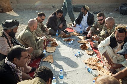 Afghan local and national policemen talk with coalition force members during a meeting to discuss self-sustainment of the police forces in Afghanistan's Farah province, Dec. 3, 2012.