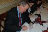 Senator Crapo signs Christmas cards for our troops serving overseas at a Red Cross Holiday Mail for Heroes event.