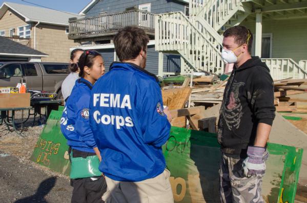 fema corps members talk with survivor