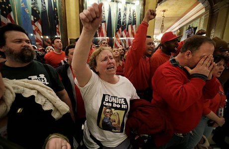Protesters gather for a rally in the rotunda at the State Capitol in Lansing, Mich., Tuesday, Dec. 11, 2012. The crowd is protesting right-to-work legislation passed last week. Michigan could become the 24th state with a right-to-work law next week. Rules required a five-day wait before the House and Senate vote on each other's bills; lawmakers are scheduled to reconvene Tuesday and Gov. Snyder has pledged to sign the bills into law. (AP Photo/Paul Sancya)
