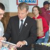U.S. Representative Mike McIntyre stuffs a care package with the U.S.O. to send to our troops overseas.