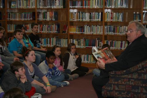 Billy reads to 4th and 5th graders at Pershing Elementary School as part of his reading initiative 