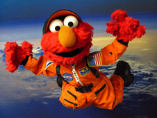 Sesame Street's Elmo in orange flight suit