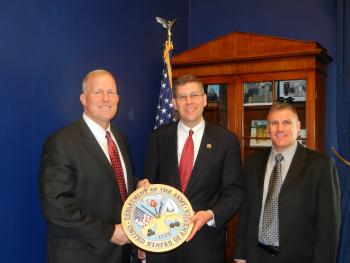 Lt. Col. Sanders and Col. McGuire present Congressman Paulsen with Army Seal