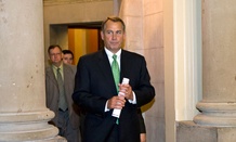 John Boehner walks to the House floor to deliver remarks about negotiations Tuesday.