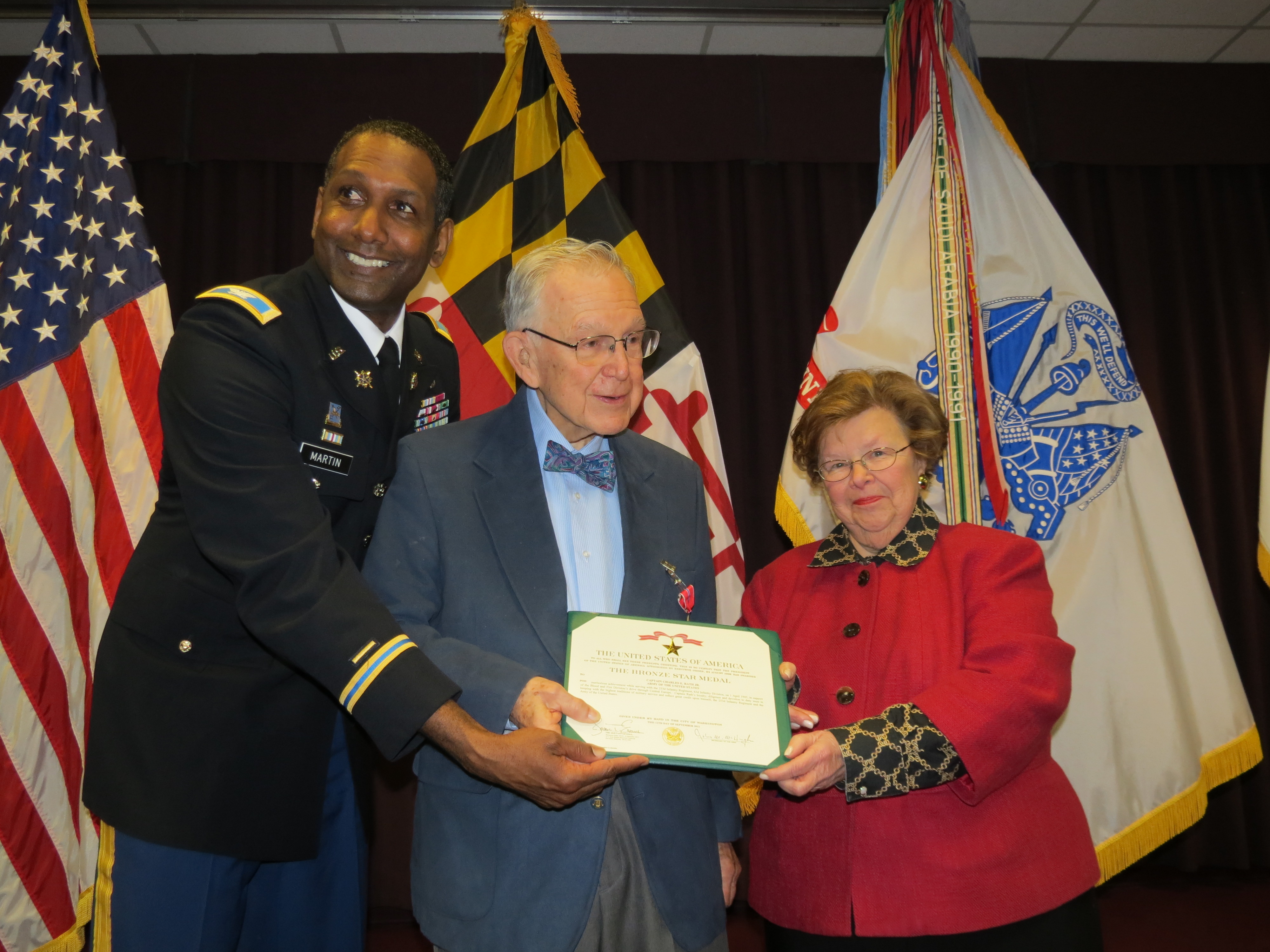 Dr. Charles Rath is presented a Bronze Star for service during WWII by Senator Mikulski and Col. Jeremy Martin.