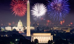 Fourth of July fireworks splash the sky with reds, whites and blues above the Lincoln Memorial, Washington Monument and U.S. Capitol.
