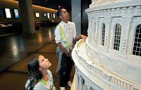Children exploring the touchable scale model of the Capitol dome in the Capitol Visitor Center's Exhibition Hall