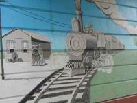 The south side of the overpass depicts St. Albans as it was when the railroad first arrived, with a chuffing steam engine.