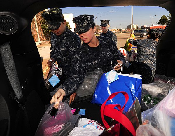 Aviation Ordnanceman 3rd Class Jered Gonzalez and Aviation Ordnanceman Airman Elizabeth Swecker, both assigned to the aircraft carrier USS Theodore Roosevelt (CVN 71), help deliver Christmas presents to a Salvation Army warehouse. Theodore Roosevelt Sailors donated a total of 225 gifts to the Angel Tree program and helped distribute the presents to underprivileged children. Theodore Roosevelt is in the last year of refueling and complex overhaul at Newport News Shipbuilding, a division of Huntington Ingalls Industries.  U.S. Navy photo by Mass Communication Specialist 2nd Class Austin Rooney (Released)  121204-N-RT381-035