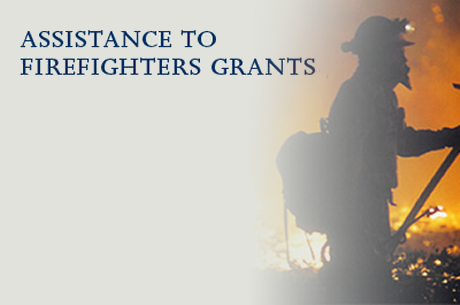 Assistance to Firefighters Grants banner with an image of a firefighters in the foreground of a fire