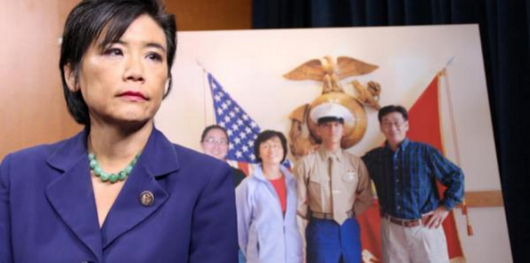 Rep. Chu at a press conference on military hazing, in front of a photo of her nephew Harry Lew.