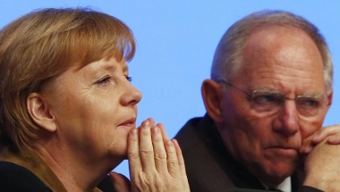 German Chancellor and leader of Germany's Christian Democratic Union (CDU), Angela Merkel (L ) talks to party fellow and Finance Minister Wolfgang Schaeuble during the CDU's annual party meeting in Hanover, December 4, 2012. REUTERS/Kai Pfaffenbach 
