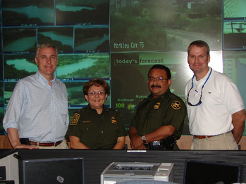 Congressmen Murphy and Barrett with the Acting Chief of the Border Patrol. The screens in the background show the border monitored by 43 cameras.