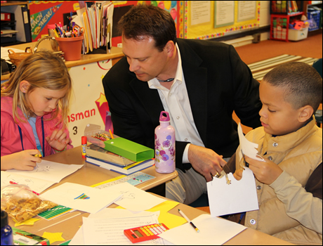 Congressman Shuler makes holiday cards for the troops with third graders at Glen Arden Elementary.
