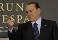 Former Italian Prime Minister Silvio Berlusconi gestures as he arrives to attend the book launch of his friend, TV presenter Bruno Vespa, in Rome December 12, 2012. REUTERS/Tony Gentile