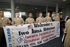 Group of US Marines greeting veterans on the Greatest Generations Foundation program upon arrival in Honolulu.