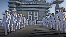 Sailors man the rails during the homecoming of the Nimitz-class aircraft carrier USS Dwight D. Eisenhower