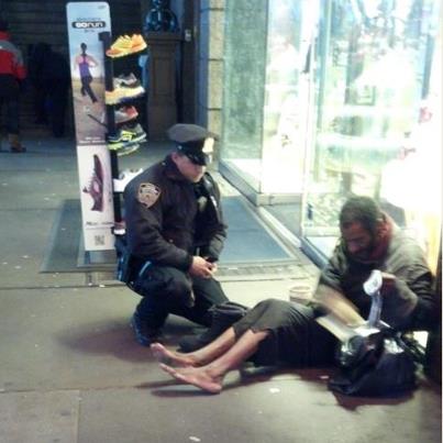 Photo: Jennifer Foster of Florence, AZ was visiting Times Square with her husband Nov. 14 when they saw a shoeless man asking for change. She writes, “Right when I was about to approach, one of your officers came up behind him. The officer said, ‘I have these size 12 boots for you, they are all-weather. Let’s put them on and take care of you.’ The officer squatted down on the ground and proceeded to put socks and the new boots on this man. The officer expected NOTHING in return and did not know I was watching*. I have been in law enforcement for 17 years. I was never so impressed in my life. I did not get the officer’s name. It is important, I think, for all of us to remember the real reason we are in this line of work. The reminder this officer gave to our profession in his presentation of human kindness has not been lost on myself or any of the Arizona law enforcement officials with whom this story has been shared.”
Our thanks to the Fosters for their attention and appreciation, and especially to this officer, who remains anonymous.  

Send us your NYPD snapshots via Facebook message, and/or email the Department through http://www.nyc.gov/html/mail/html/mailnypd.html.

*image cropped from the distance at which it was taken