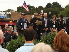 Rep. Hayworth, Putnam County Executive Paul Eldrige and F.O.P. President James O'Neill listen as Father Anthony Sorgie of St. James the Apostle Church delivers the invocation at the Putnam County 9/11 remembrance ceremony in Carmel
