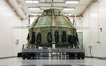 The Orion Exploration Flight Test 1 crew module undergoes proof pressure testing at the Operations and Checkout Building, Kennedy Space Center. Image credit: NASA/Ben Smegelsky