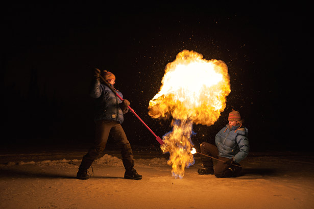 Picture of researchers releasing methane from a frozen Arctic lake