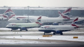 British Airways aircraft taxi after snowfall at Heathrow airport in London January 21, 2013. REUTERS/Neil Hall 