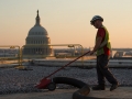 Work Photography of a Worker repairing the Hart Roof at sunset.