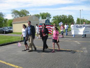 Representative Peters honors Americas heroes in the Waterford Memorial Day Parade with daughters Madeline (left) and Alana, and wife Colleen