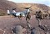 U.S. Marines offload from an MV-22B Osprey aircraft during sustainment training in D'Arta Plage, Djibouti, Dec. 1, 2014. The Marines are assigned to Golf Company, Battalion Landing Team 2nd Battalion, 1st Marines, 11th Marine Expeditionary Unit and the aircraft crew is assigned to Marine Medium Tiltrotor Squadron 163 Reinforced, 11th Marine Expeditionary Unit. The Makin Island Amphibious Ready Group and the embarked 11th MEU are deployed in support of maritime security operations and theater security cooperation efforts in the U.S. 5th Fleet area of responsibility. U.S. Marine Corps photo by Cpl. Laura Y. Raga