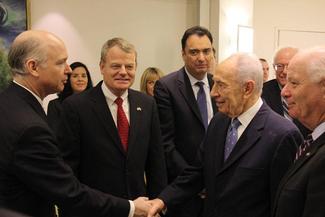 Representatives Aderholt and McIntyre, Secretary Camuñez and Senators Sanders and Cardin with President Peres. 