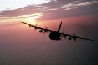 A silhouetted air-to-air view of an AC-130 Hercules from the 16th Special Operations Squadron.