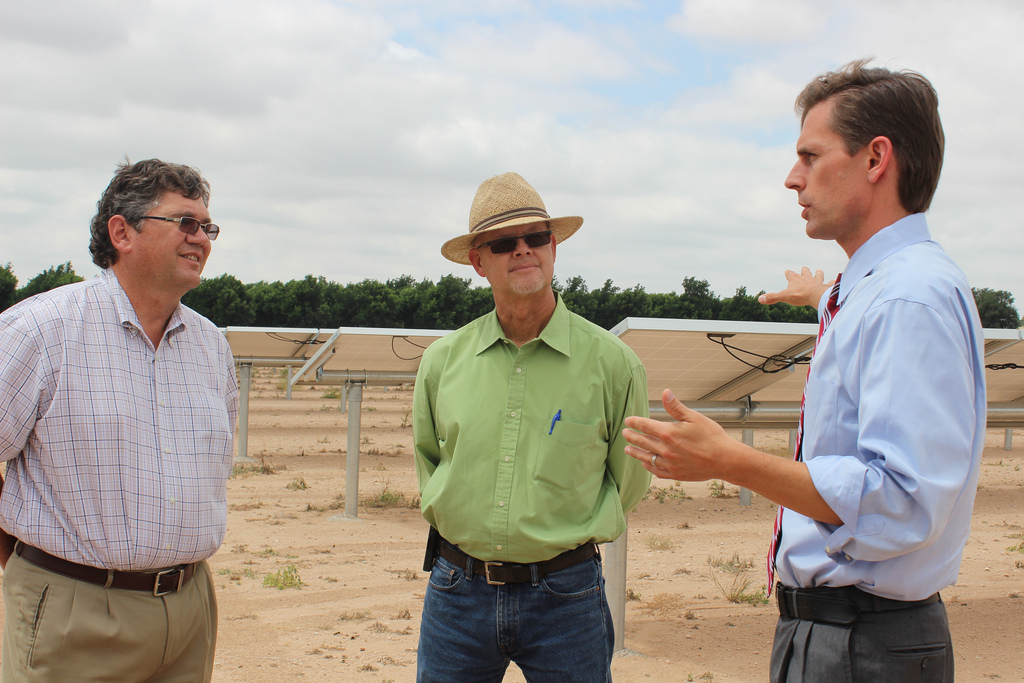 U.S. Senator Martin Heinrich (D-N.M.) talks with Bruce Haley, owner of Haley Farms, and staffer Varney Brant on how renewable energy programs can help New Mexico's agriculture industry. 