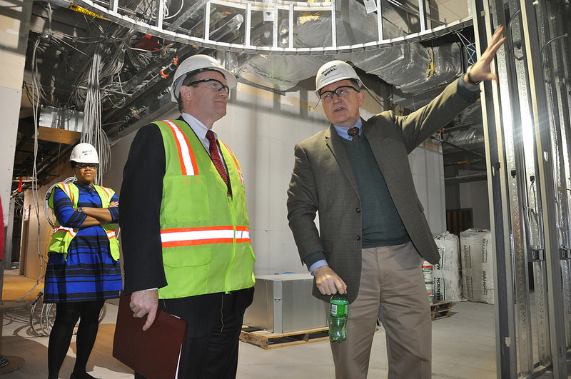 Sen. Coons listens to Community Education Building president Riccardo Stoeckicht as they stand in what will be the CEB's 7,000 square foot library on January 17, 2014.