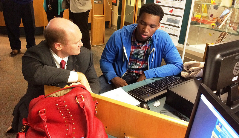 Senator Coons works on a college application with student Tah-Jay McLaughlin during a visit to Mt. Pleasant High School on November 15, 2013 for College Application Month.