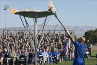 Photo of Master Sgt. Christopher Aguilera lighting the cauldron signifying the beginning of the Air Force Wounded Warrior Trails.