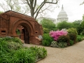 The Summerhouse on the Capitol Grounds surrounded by pink azalea flowers.