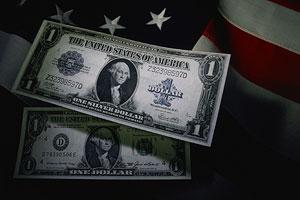 Dollar bills in front of the US flag