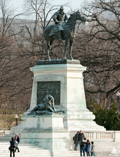 The bronze and marble Ulysses S. Grant Memorial by Henry Merwin Shrady is located by the reflecting pool at the east end of the National Mall, west of the United States Capitol. Its central figure depicts the Civil War general (and future president) seated and still on horseback, as was his custom while observing a battle; bronze reliefs on the marble pedestal show infantry soldiers on the march. 