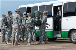 Service members assigned to Joint Forces Command – United Assistance wear uniforms treated in insect repellent while unloading bags at Barclay Training Center, Monrovia, Liberia, Dec. 3, 2014. In addition to the uniforms, precautionary measures like spraying insect repellent and eliminating standing pools of water are put in place to prevent breeding grounds for mosquitoes, which carry malaria. Operation United Assistance is a Department of Defense operation in Liberia to provide logistics, training and engineering support to U.S. Agency for International Development-led efforts to contain the Ebola virus outbreak in western Africa. Portions of this image were masked for privacy reasons. (U.S. Army photo by Staff Sgt. V. Michelle Woods, 27th Public Affairs Detachment/RELEASED)