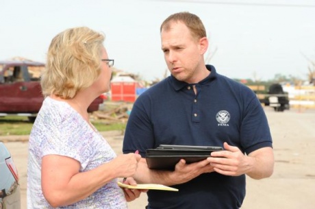 FEMA Disaster Survivor Assistance Team (DSAT) member, Matt Behnke, assists local resident Donitta Griffen outside of her house which was impacted by the recent tornado on May 20, 2013.