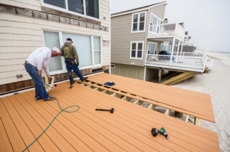 Shorefront homeowners rebuild their deck after it collapsed during Hurricane Sandy.