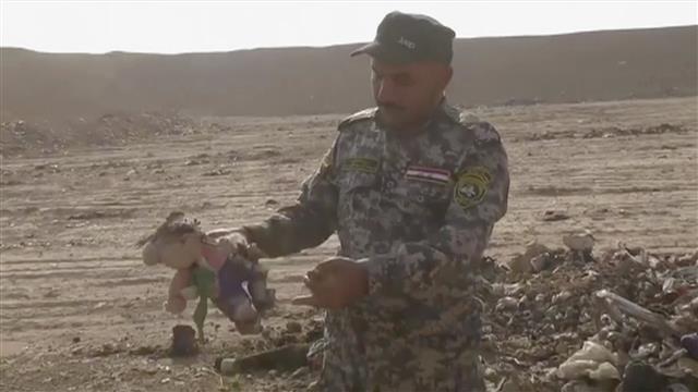 Iraqi troops discovered a mass grave on Monday containing 100 bodies, many of which were decapitated. The bodies were found some 30 miles southeast of Mosul in the town of Hamam al-Alil. Photo: AP