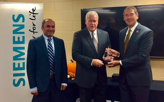 Mississippi Congressman Gregg Harper receives award from Muhammad Sohail, vice president of Siemens High Voltage Products and NAM President and CEO Jay Timmons. 