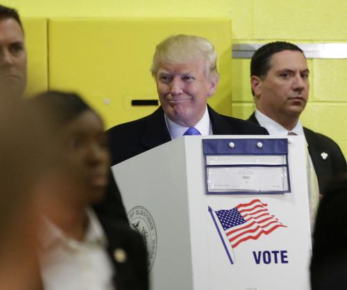 Donald Trump casts vote in NYC hours after topless protesters removed