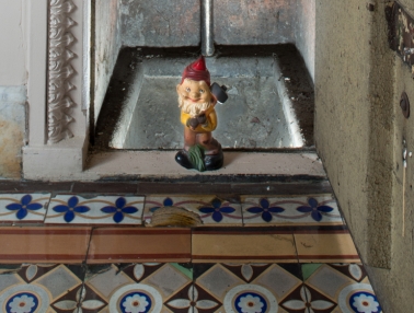 A garden gnome placed in an open "tiny" door in the U.S. Capitol.