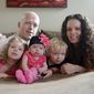In this Sept. 1, 2014, photo, Willow Short, 4-month-old, center, along with her parents Megan and Mark and sister Liana, 6, and brother Mark, 3, poses for a photo in Sinking Spring, Pa. Willow Short had a heart transplant at 6-days-old. The couple featured in news stories about their difficulties getting medication for the daughter who had a heart transplant were found shot to death in their home along with their three children in apparent murder-suicide, authorities said Sunday, Aug. 7, 2016. (Susan L. Angstadt/Reading Eagle via AP)